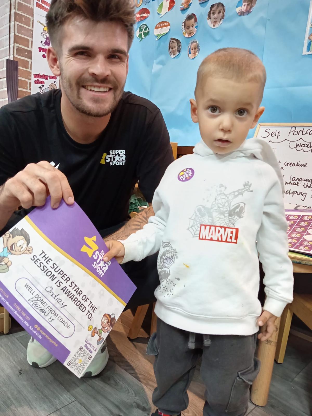 Nursery staff guiding a child through an activity