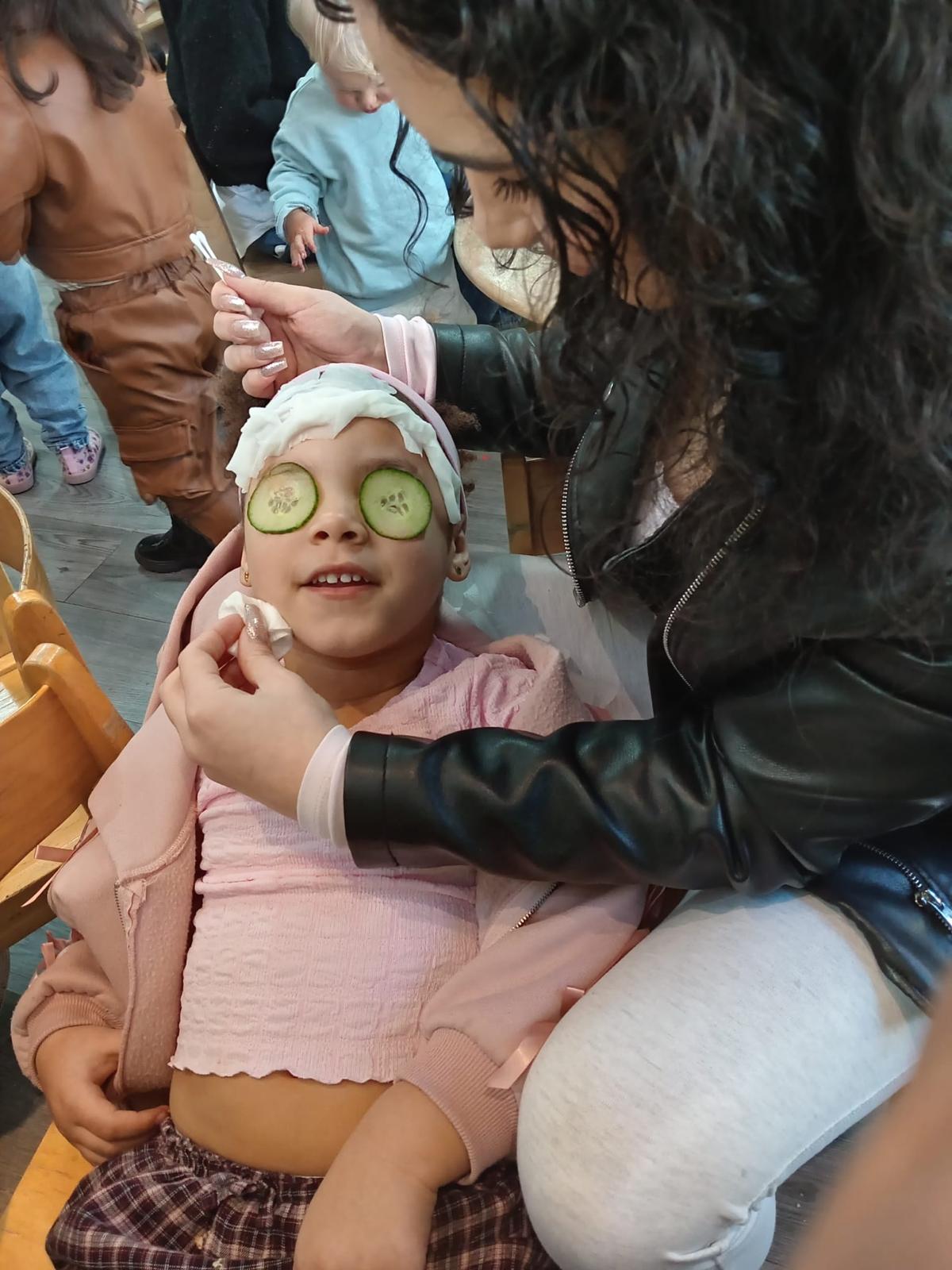 Nursery staff supporting a child in a calm activity